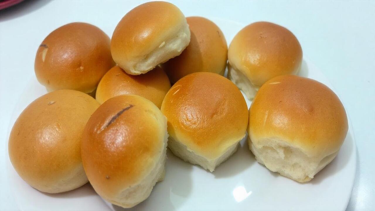 pikaso texttoimage Freshly baked dinner rolls on a plate some whole a